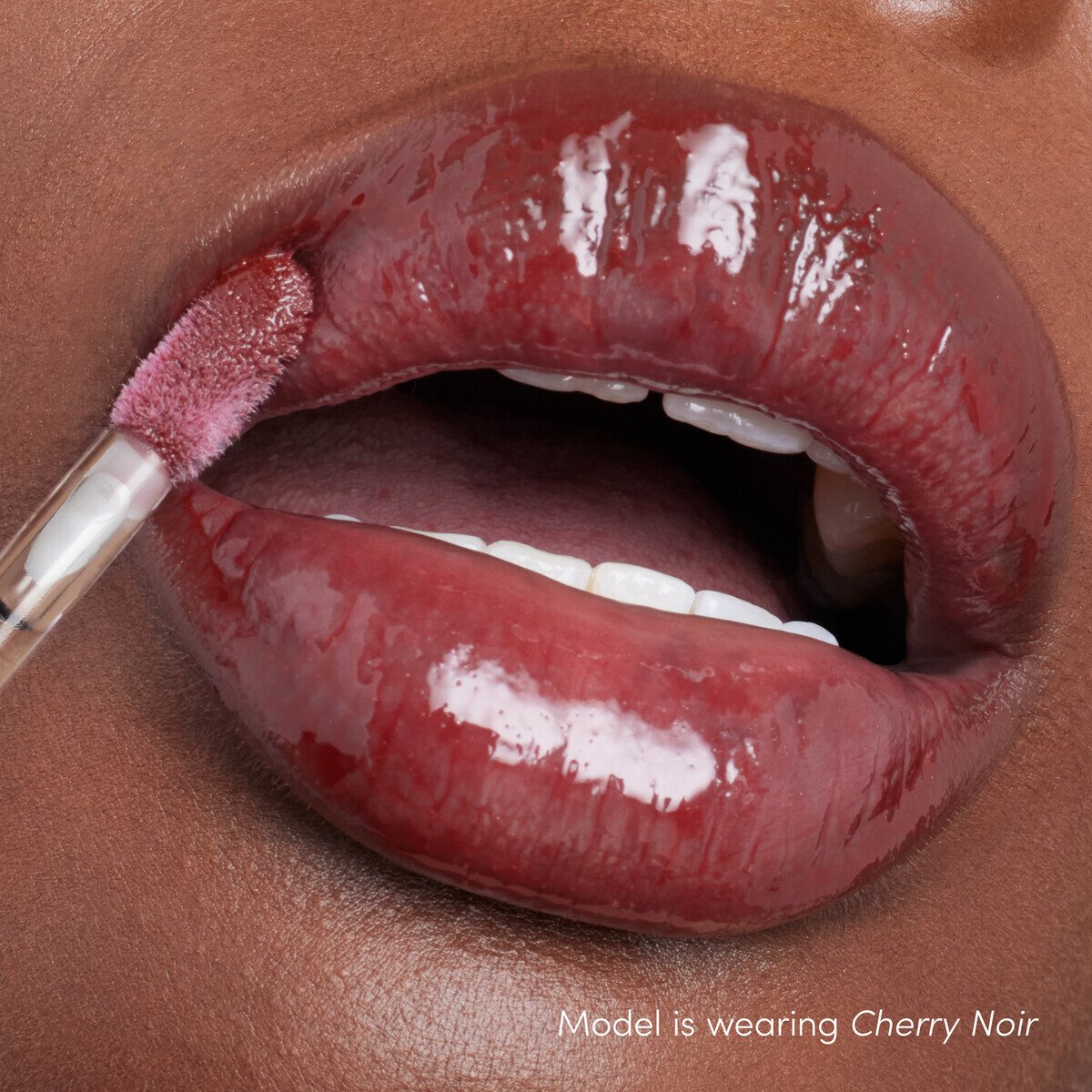 Jane Iredale ColorLuxe High Impact Lip Glaze, shade Cherry Noir, on lips